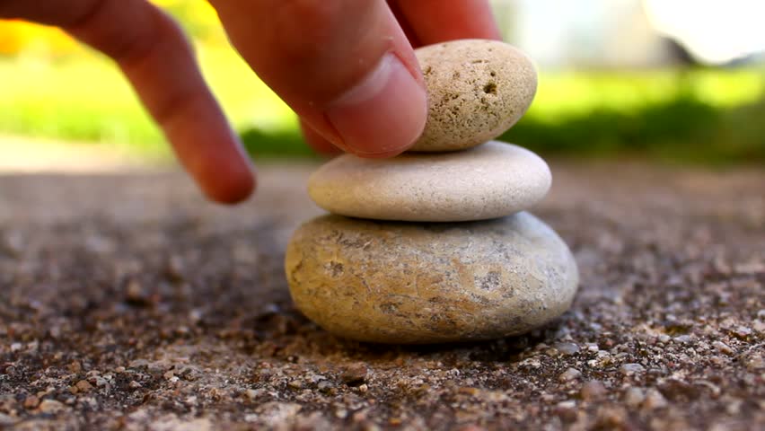 Balanced stack of stones symbolising structured, layered institution-building